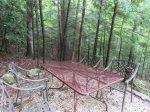 Wrought iron picnic table just behind the cabin in a little hemlock glen